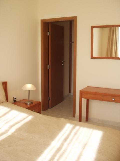 Door to clothes hanging area and en-suite bathroom